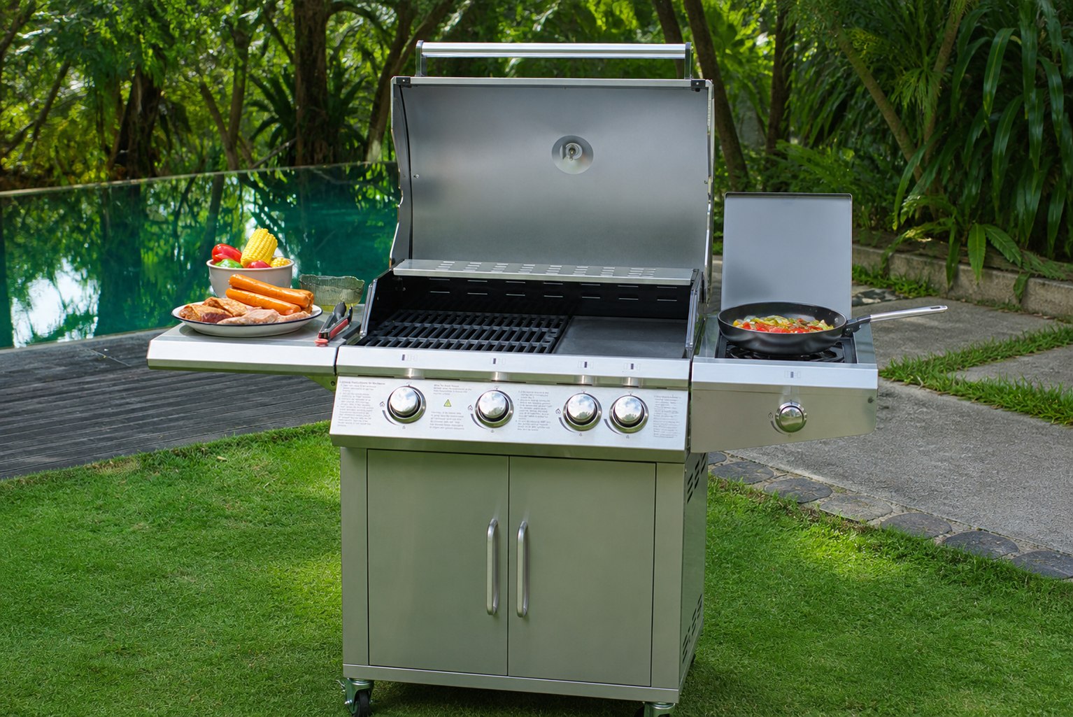 Open stainless steel grill showing the cooking surface, side burner and cabinet