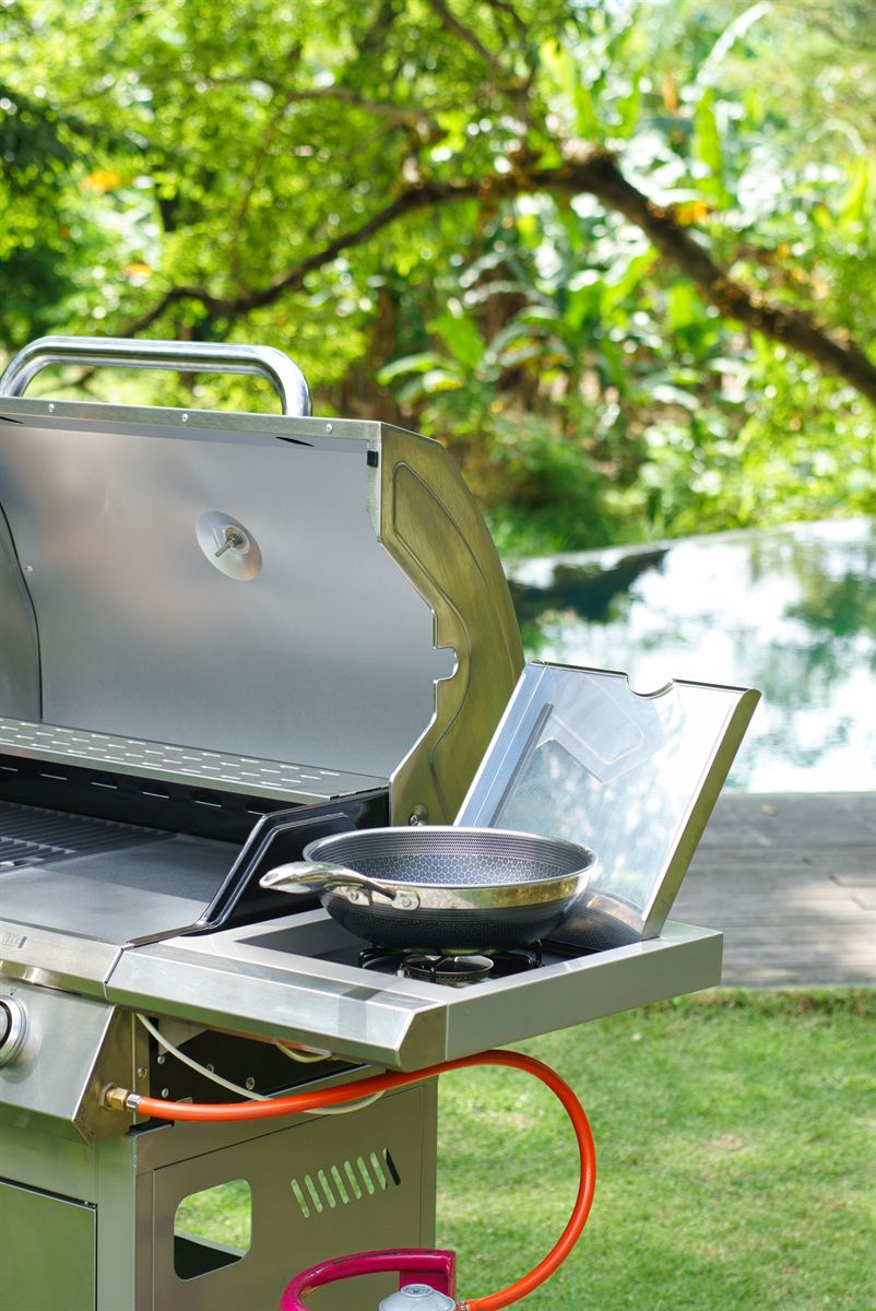 Side burner and wok detail on the stainless steel grill